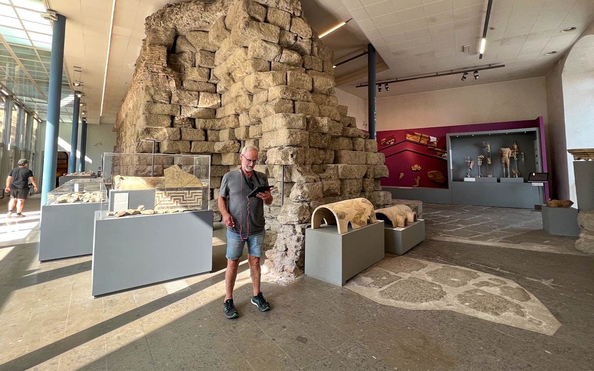Man viewing ancient artifacts at Musei Capitolini, Rome.