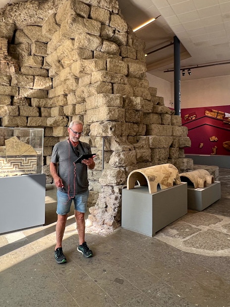Man viewing ancient artifacts at Musei Capitolini, Rome.