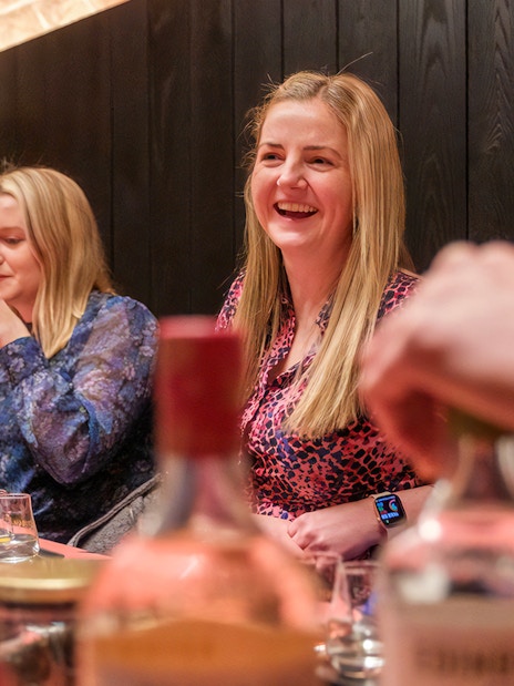 Visitors enjoying a whisky tasting at an Edinburgh distillery.