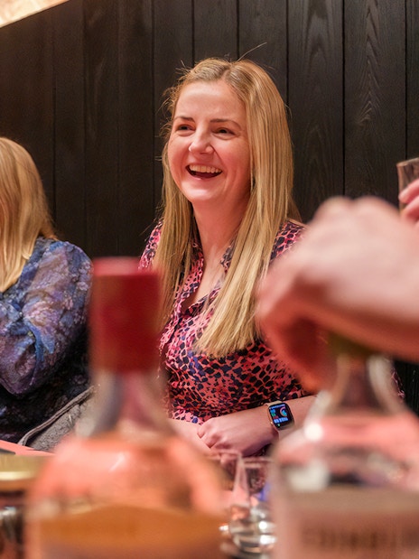 Visitors enjoying a whisky tasting at an Edinburgh distillery.