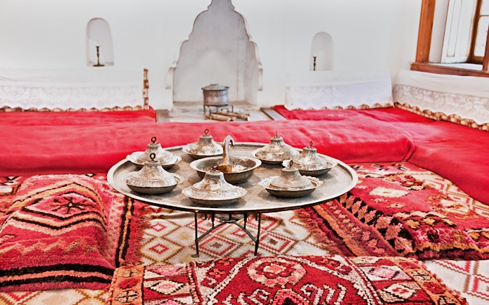 Traditional Albanian room with metal serving dishes on a tray, inside ethnographic museum, Kruje.