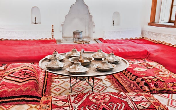 Traditional Albanian room with metal serving dishes on a tray, inside ethnographic museum, Kruje.