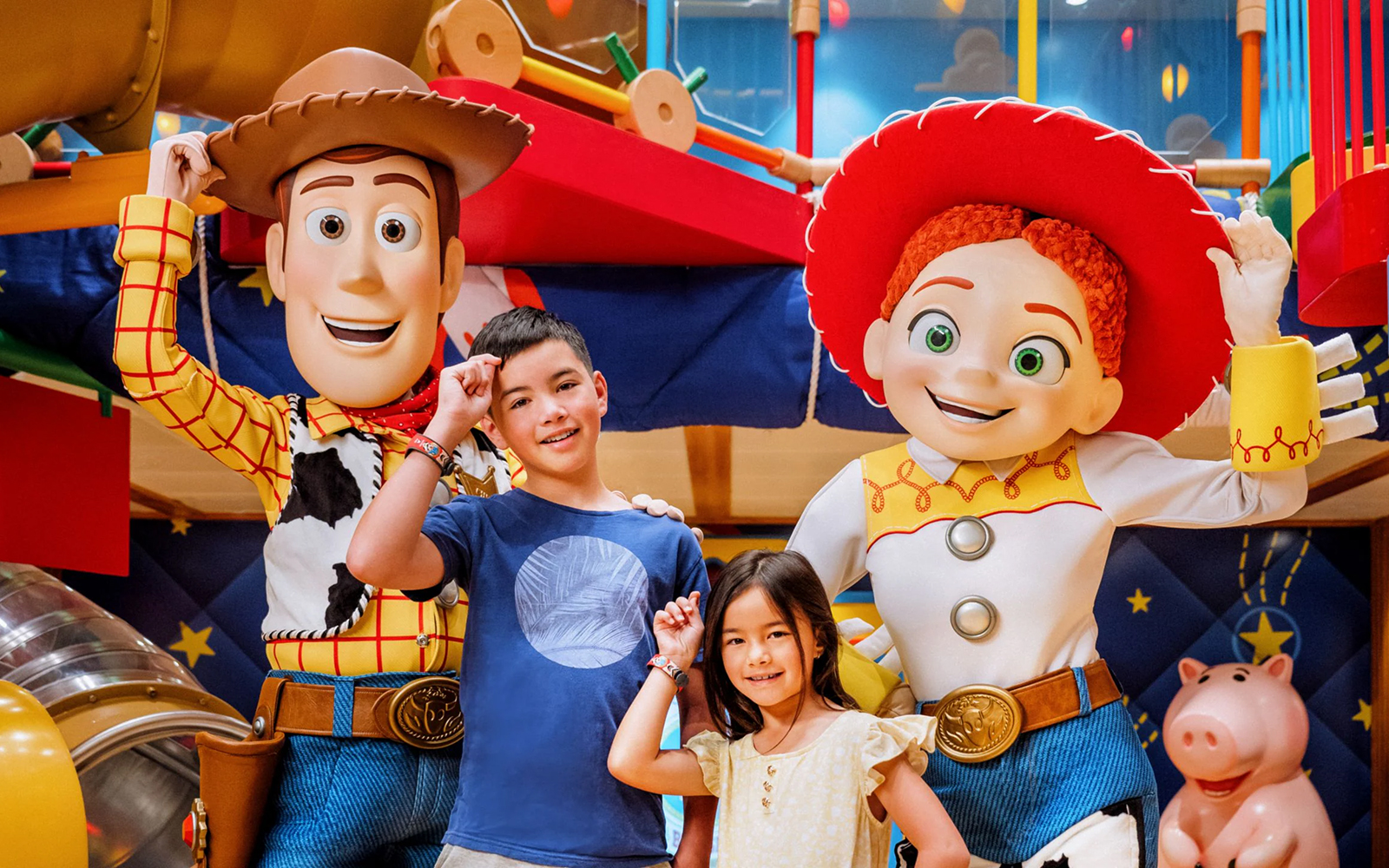 Children interacting with Pixar Pals characters on a Disney cruise.