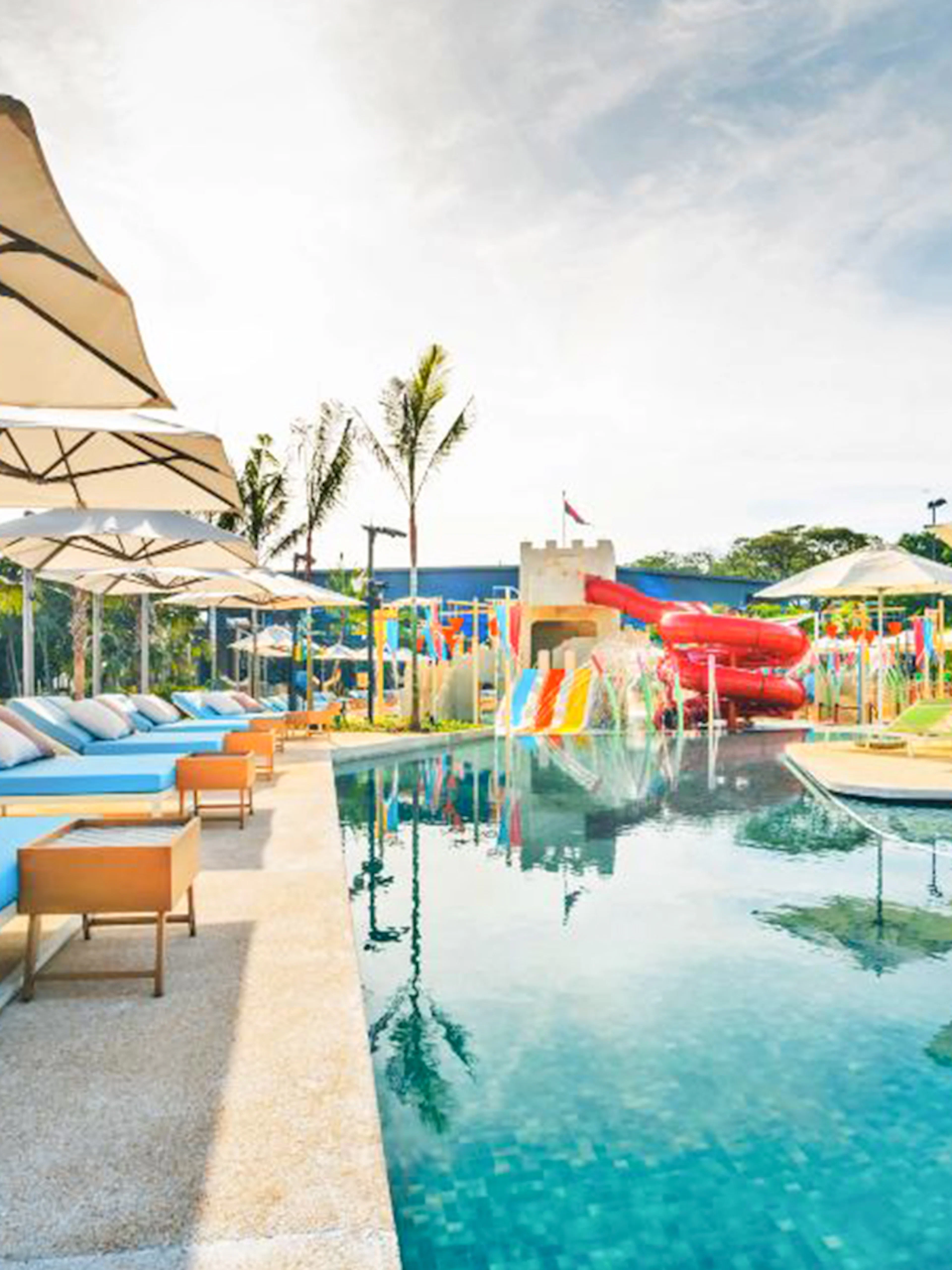 Poolside loungers and water slides at Splash Tribe resort.
