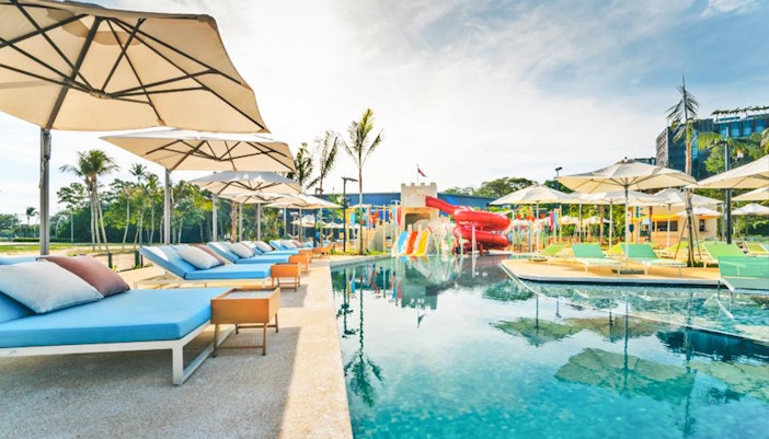 Poolside loungers and water slides at Splash Tribe resort.