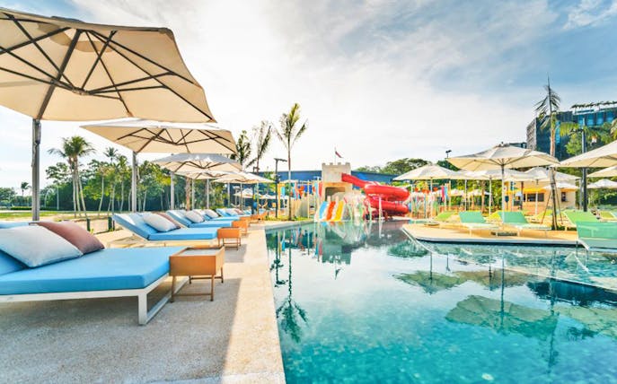 Poolside loungers and water slides at Splash Tribe resort.