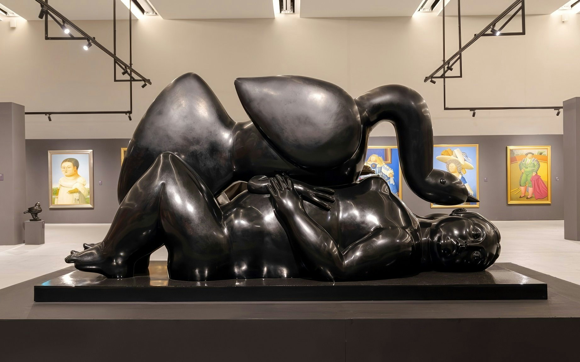 Sculpture of a reclining figure with a swan in a Boterismo art gallery.
