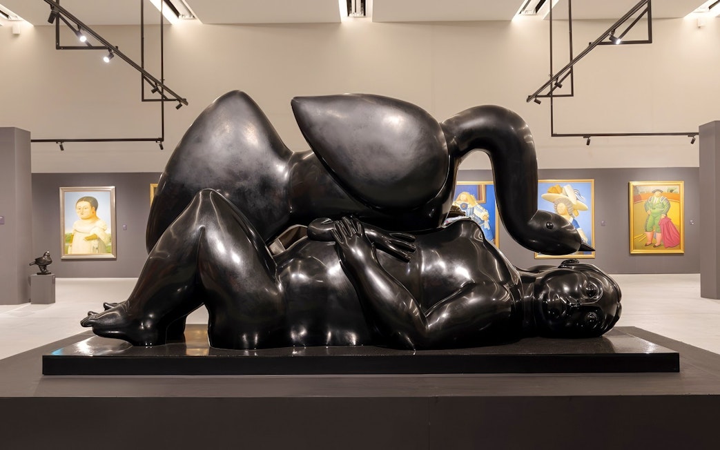 Sculpture of a reclining figure with a swan in a Boterismo art gallery.