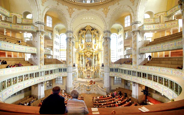 Interior view of Frauenkirche's ornate gallery during a guided tour in Dresden, Germany.