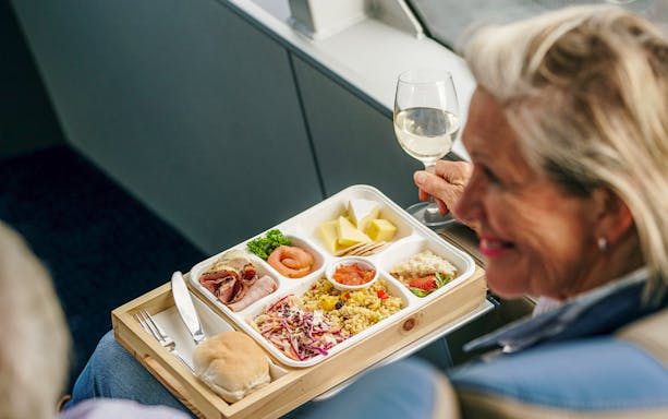 Lunch served on Gordon River cruise from Strahan, featuring assorted meats, salad, and wine.
