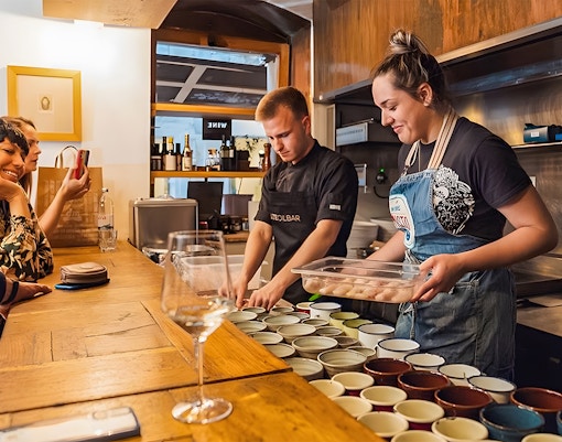 Wine tasting preparation in Diocletian's Palace, Split, with guests observing.