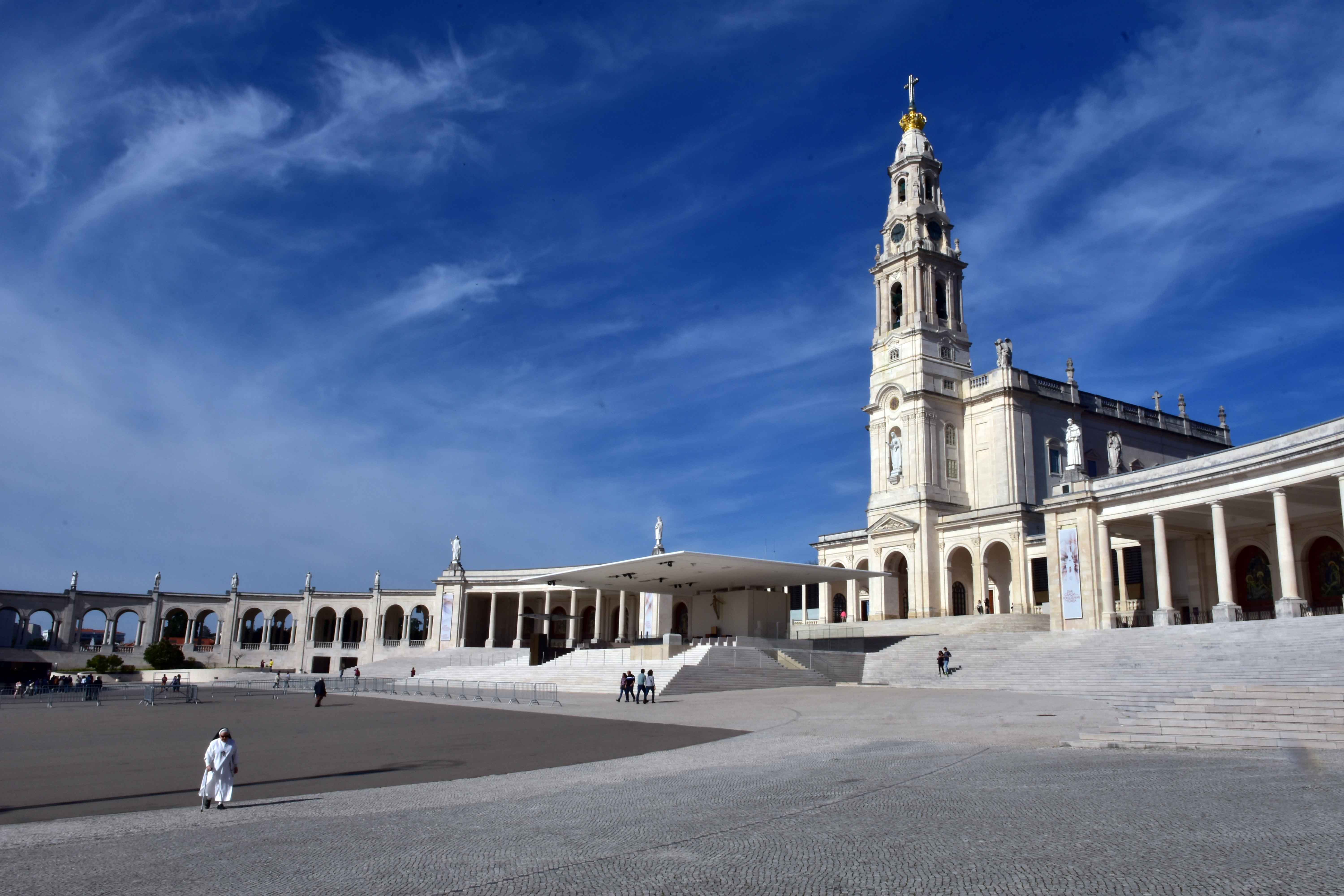 Fatima Sanctuary with bell tower under blue sky, Portugal.