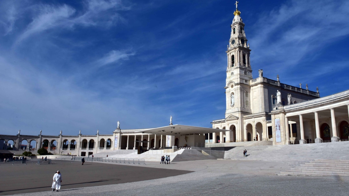 Fatima Sanctuary with bell tower under blue sky, Portugal.