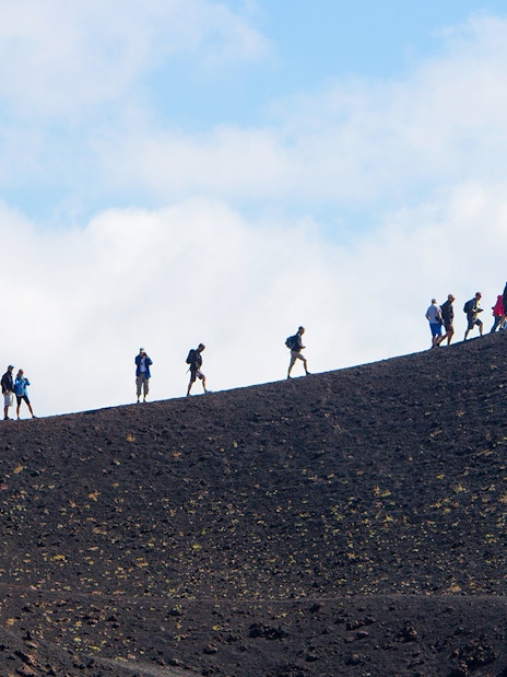 Hikers ascending Mount Etna in Sicily, Italy.