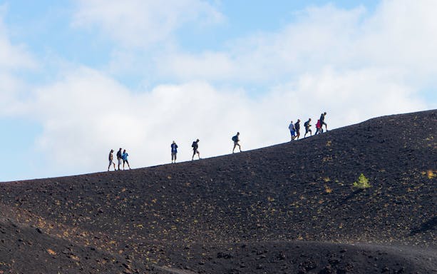 Hikers ascending Mount Etna in Sicily, Italy.