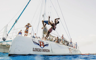 People diving off a catamaran during a mini cruise to Papagayo Beaches, Lanzarote.