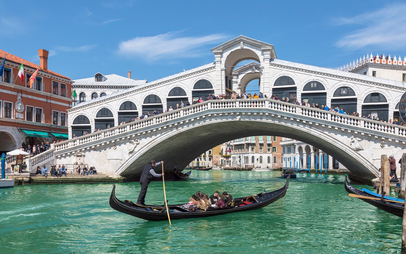 Gondola on Grand Canal near Rialto Bridge during small-group tour in Venice.