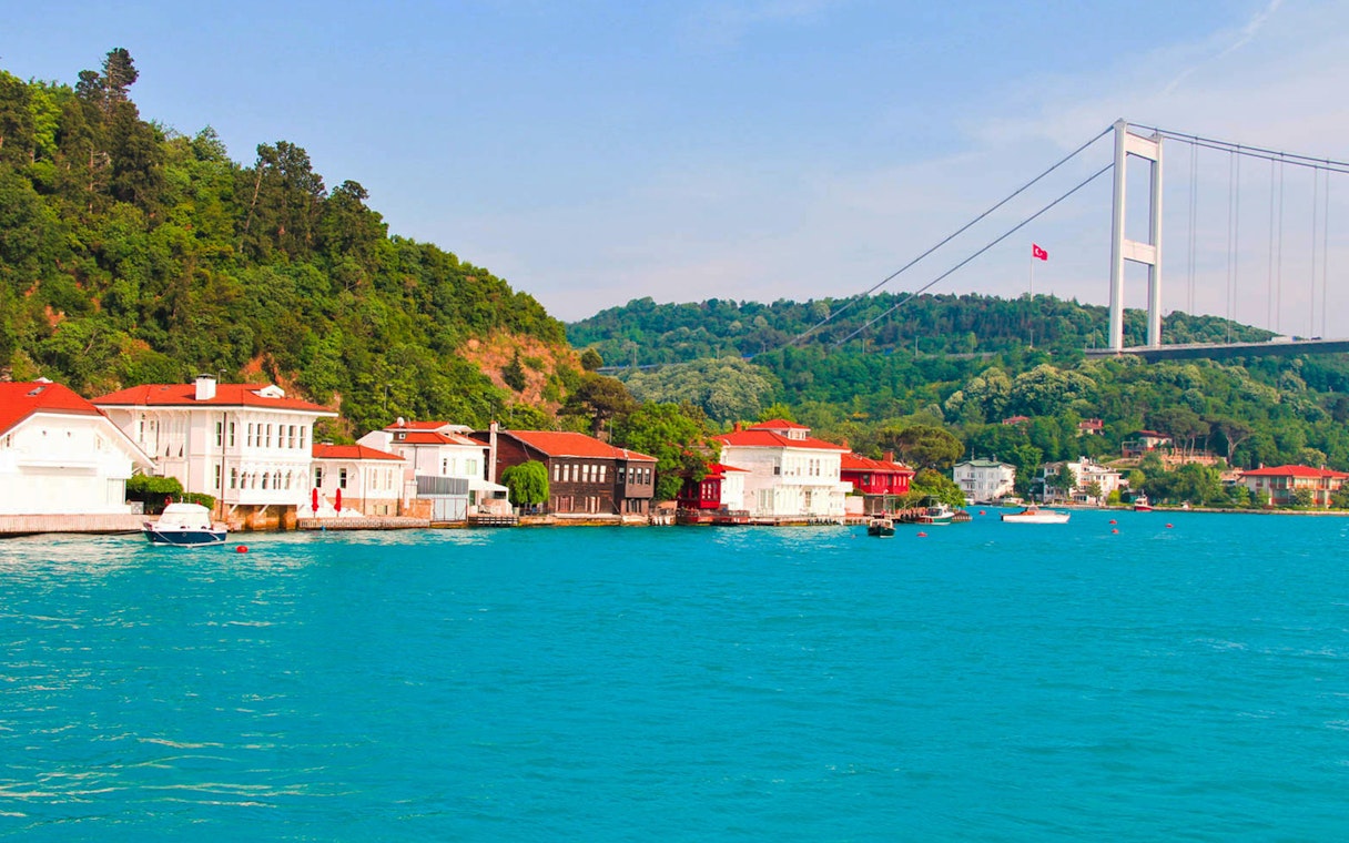 Bosphorus Strait with waterfront houses and bridge in Istanbul.
