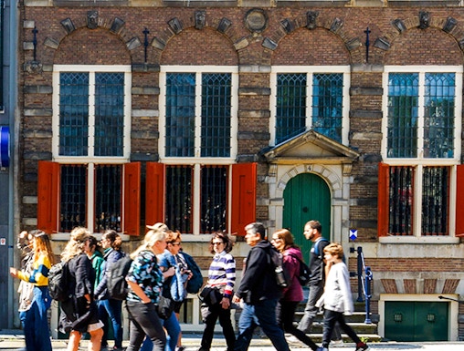 Rembrandt House Museum facade with visitors walking, Amsterdam.