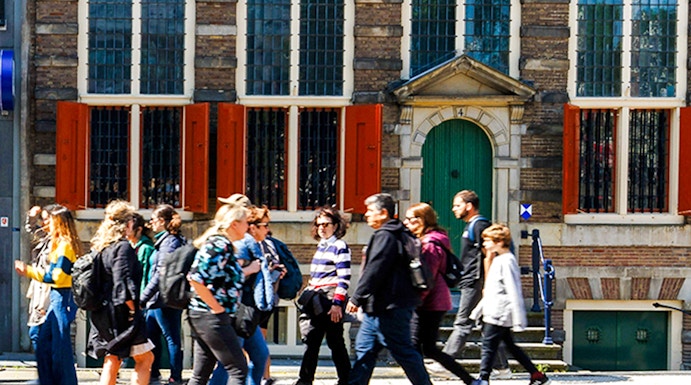 Rembrandt House Museum facade with visitors walking, Amsterdam.