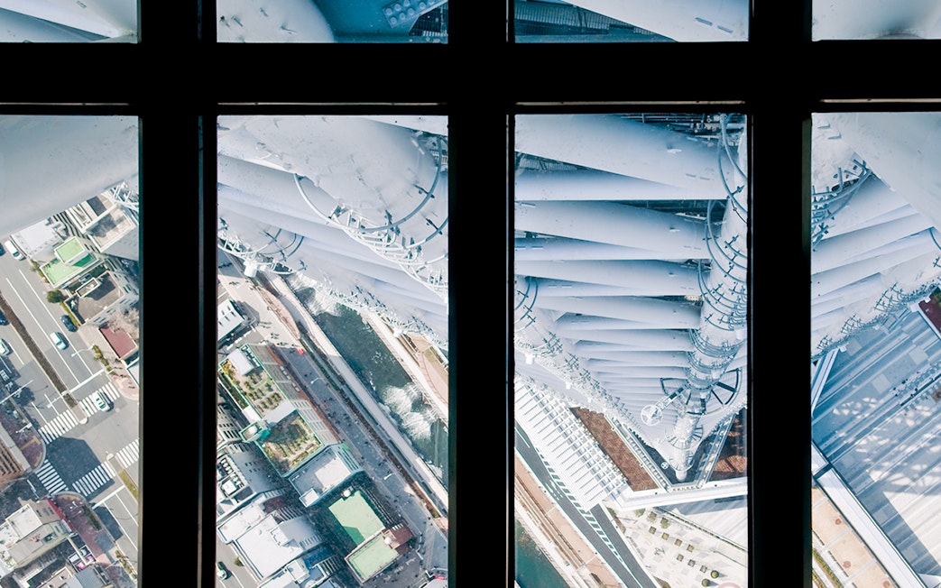 View from Tokyo Skytree observation deck overlooking city streets below.