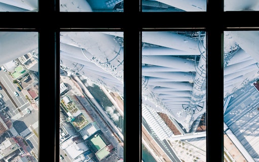 View from Tokyo Skytree observation deck overlooking city streets below.