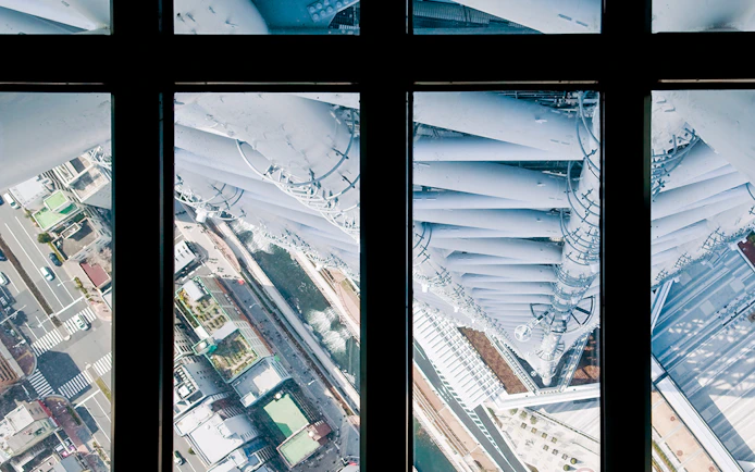 View from Tokyo Skytree observation deck overlooking city streets below.