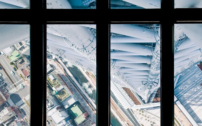 View from Tokyo Skytree observation deck overlooking city streets below.