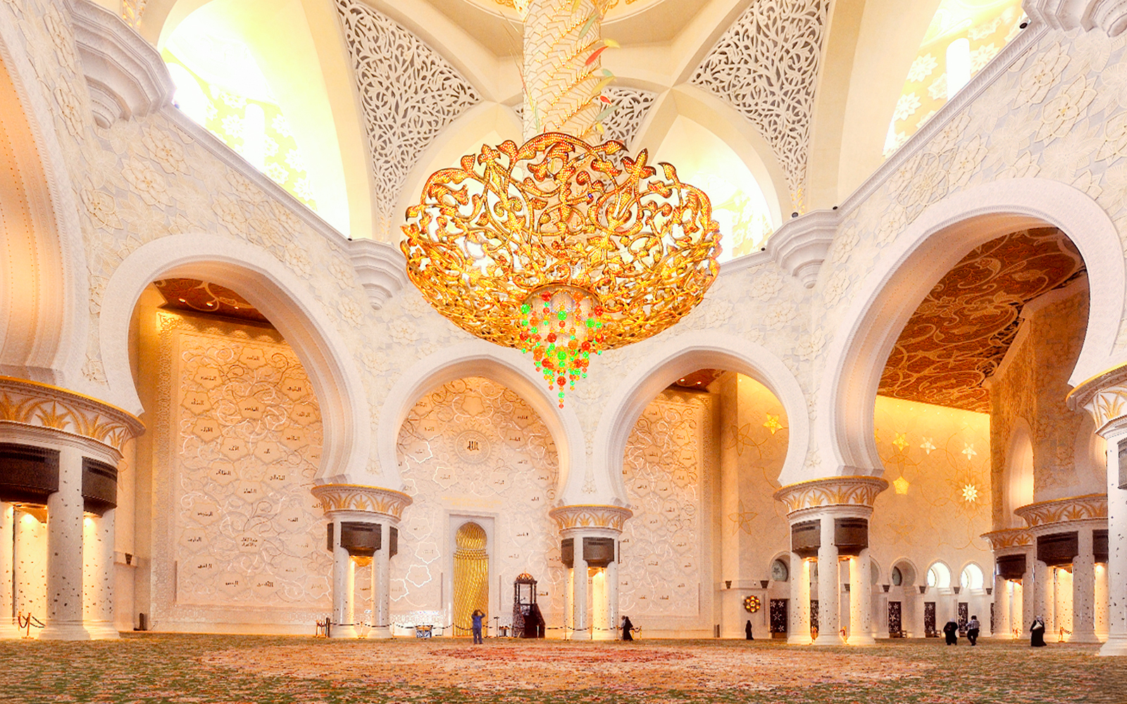 Sheikh Zayed Mosque interior with ornate chandelier and intricate wall designs, Abu Dhabi tour.