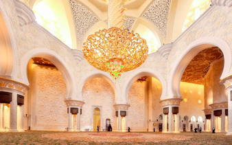 Sheikh Zayed Mosque interior with ornate chandelier and intricate wall designs, Abu Dhabi tour.