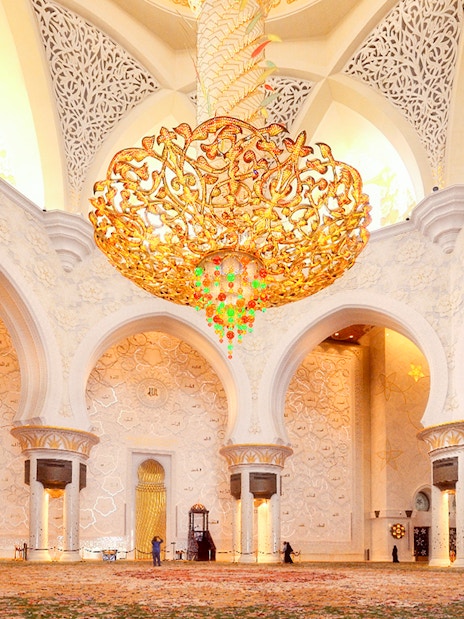 Sheikh Zayed Mosque interior with ornate chandelier and intricate wall designs, Abu Dhabi tour.