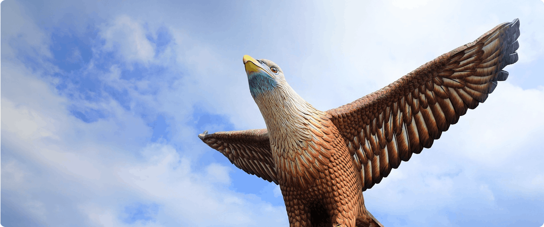Eagle Square statue in Langkawi against a blue sky.