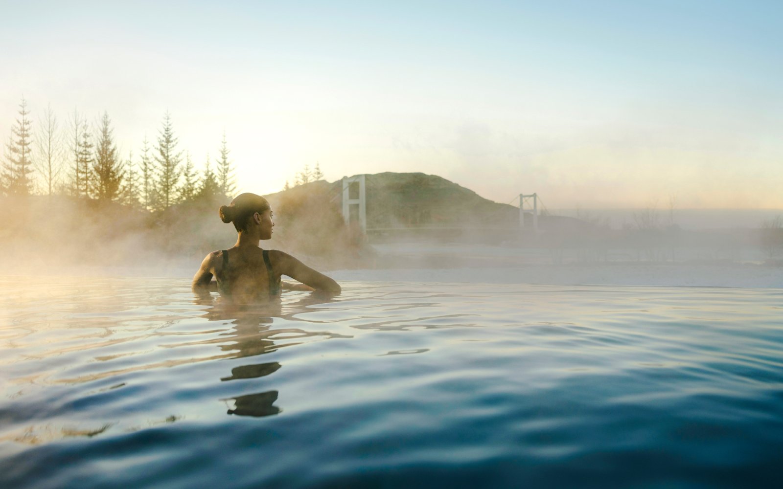 Guests enjoying the warm waters of Laugarás Lagoon's infinity pool.
