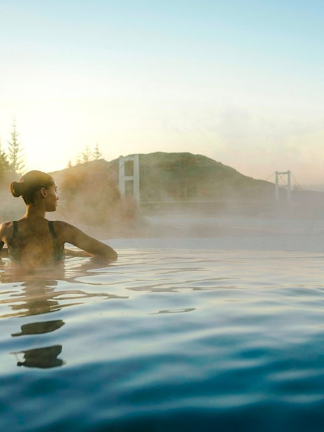 Guests enjoying the warm waters of Laugarás Lagoon's infinity pool.
