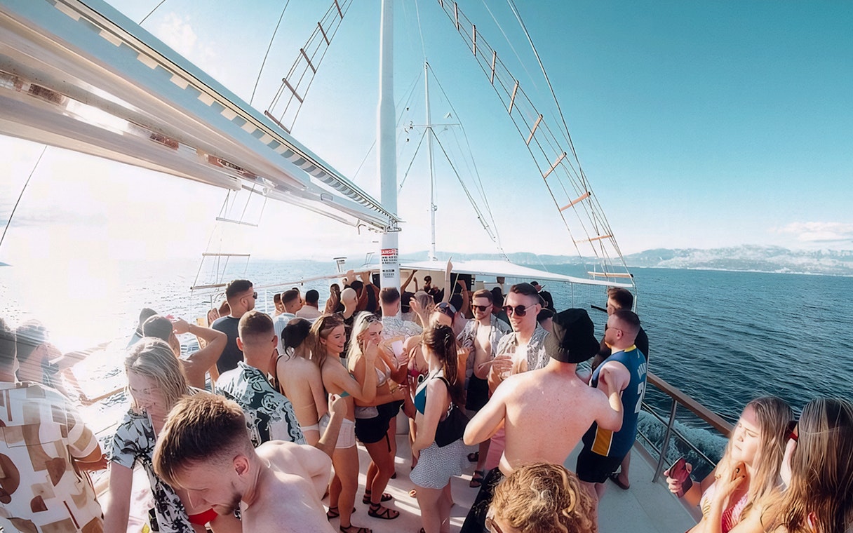 Guests enjoying Split Party Cruise on a boat with ocean views.