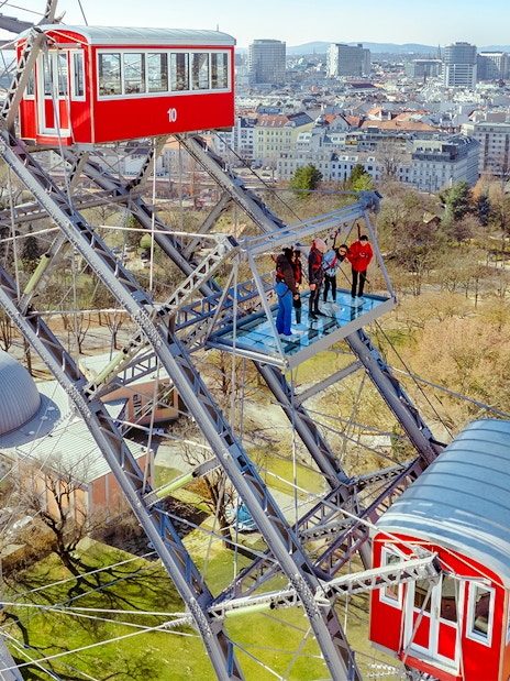 Passengers viewing Vienna cityscape from the Giant Ferris Wheel.