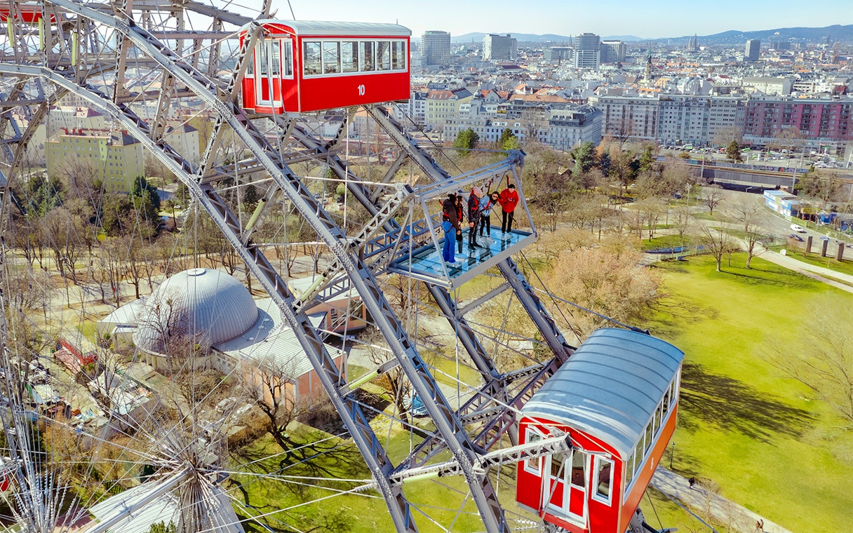 Passengers viewing Vienna cityscape from the Giant Ferris Wheel.
