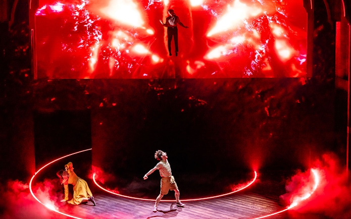 Stage performance with dramatic red lighting and actors in dynamic poses, inspired by Stranger Things.