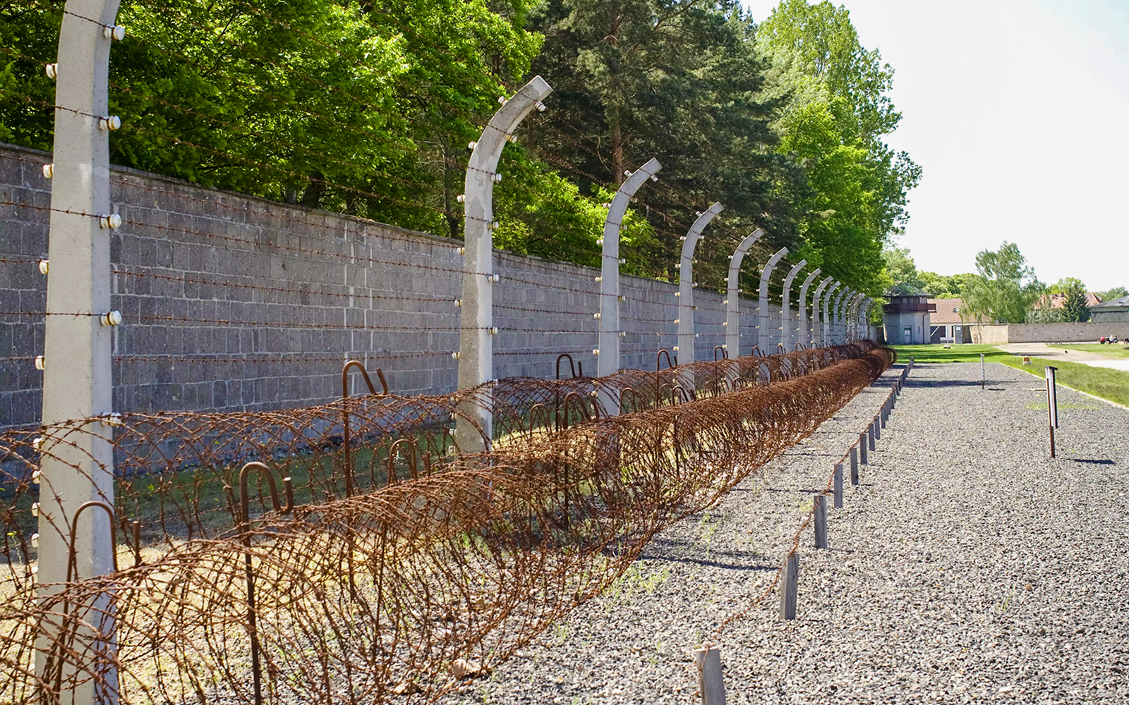 Sachsenhausen Concentration Camp Memorial barbed wire fence and gravel path.