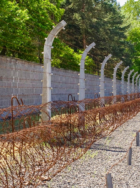 Sachsenhausen Concentration Camp Memorial barbed wire fence and gravel path.