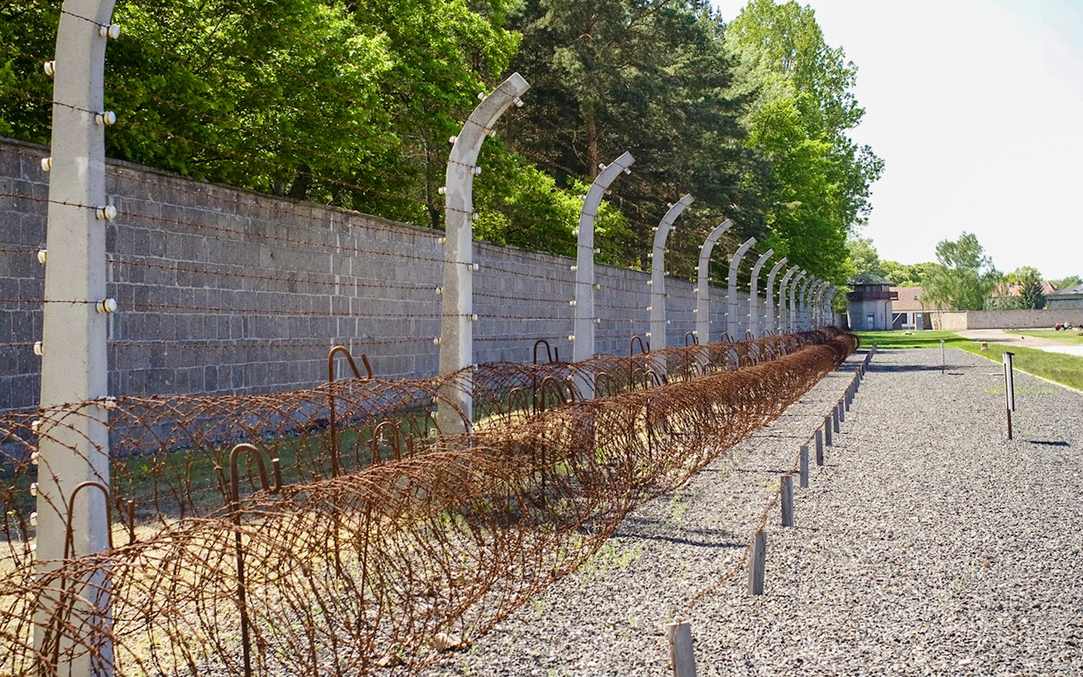 Sachsenhausen Concentration Camp Memorial barbed wire fence and gravel path.