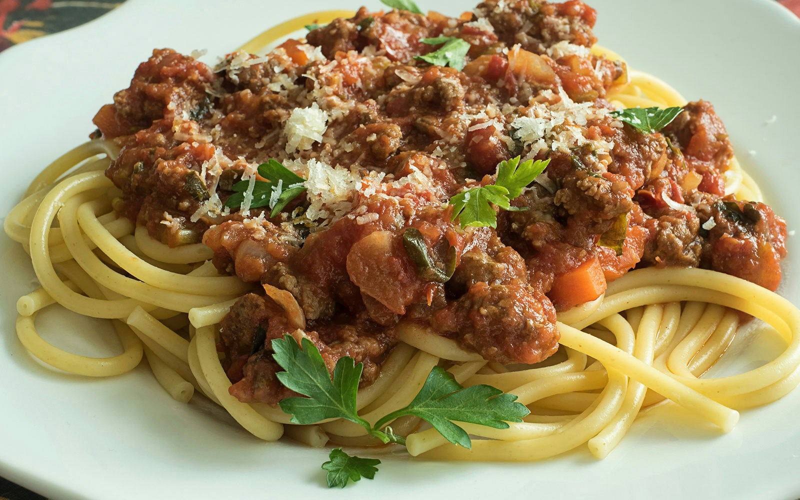 Bucatini pasta dish with tomato sauce and basil, Italian cuisine.