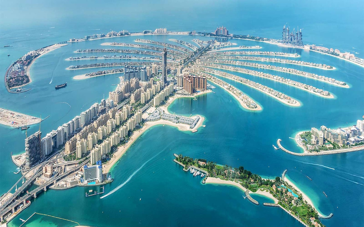 Aerial view of Palm Jumeirah island in Dubai with luxury hotels and residential buildings.