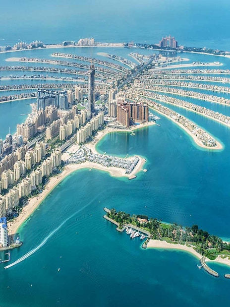 Aerial view of Palm Jumeirah island in Dubai with luxury hotels and residential buildings.
