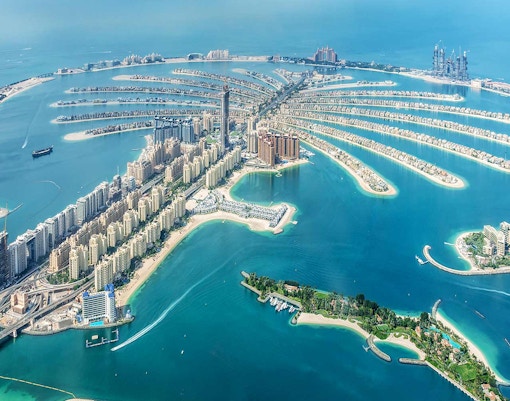 Aerial view of Palm Jumeirah island in Dubai with luxury hotels and residential buildings.