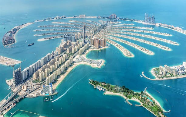 Aerial view of Palm Jumeirah island in Dubai with luxury hotels and residential buildings.
