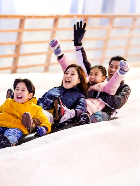 Guests sledding inside Singapore Snow City.