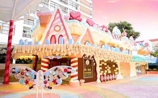Fairy Sweet Village entrance with candy-themed architecture and butterfly decoration.