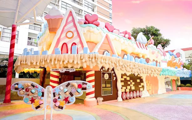 Fairy Sweet Village entrance with candy-themed architecture and butterfly decoration.