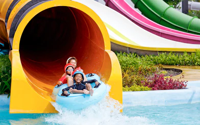 Family enjoying water slide at Yas Waterworld Abu Dhabi.